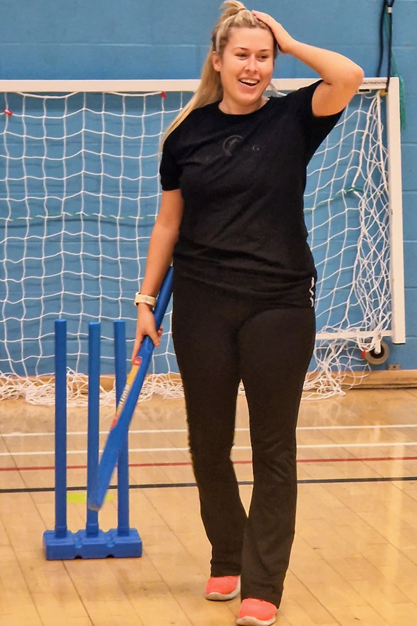 Woman playing indoor cricket